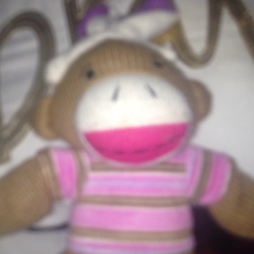 I'm selling a cute sock monkey that has bunny ears